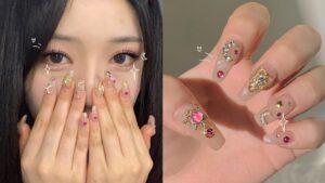 Korean gel nails with a Sailor Moon-inspired design featuring moon and star charms, pink gemstones, and a translucent jelly base.